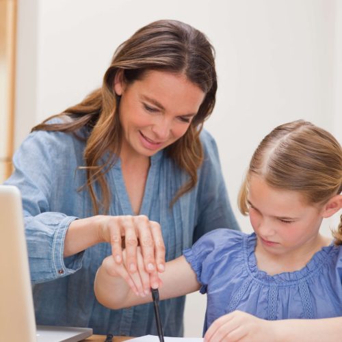 portrait-mother-helping-her-daughter-doing-her-homework