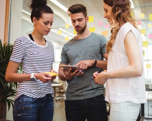 Business executives using digital tablet in office