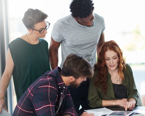 Tablet, teamwork or people in startup for news, conversation or group discussion in office together. Paperwork, meeting or colleagues planning strategy, feedback data or info online in collaboration.